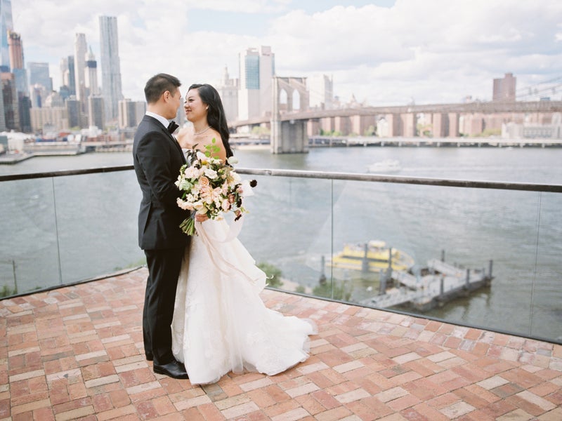A couple getting married with the Brooklyn Bridge in the background 