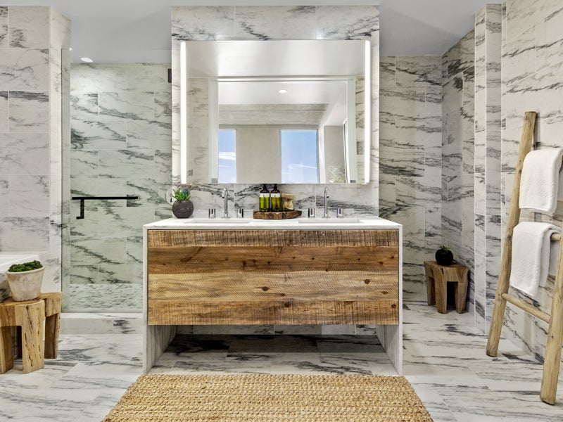 Marbled bathroom with a wooden vanity
