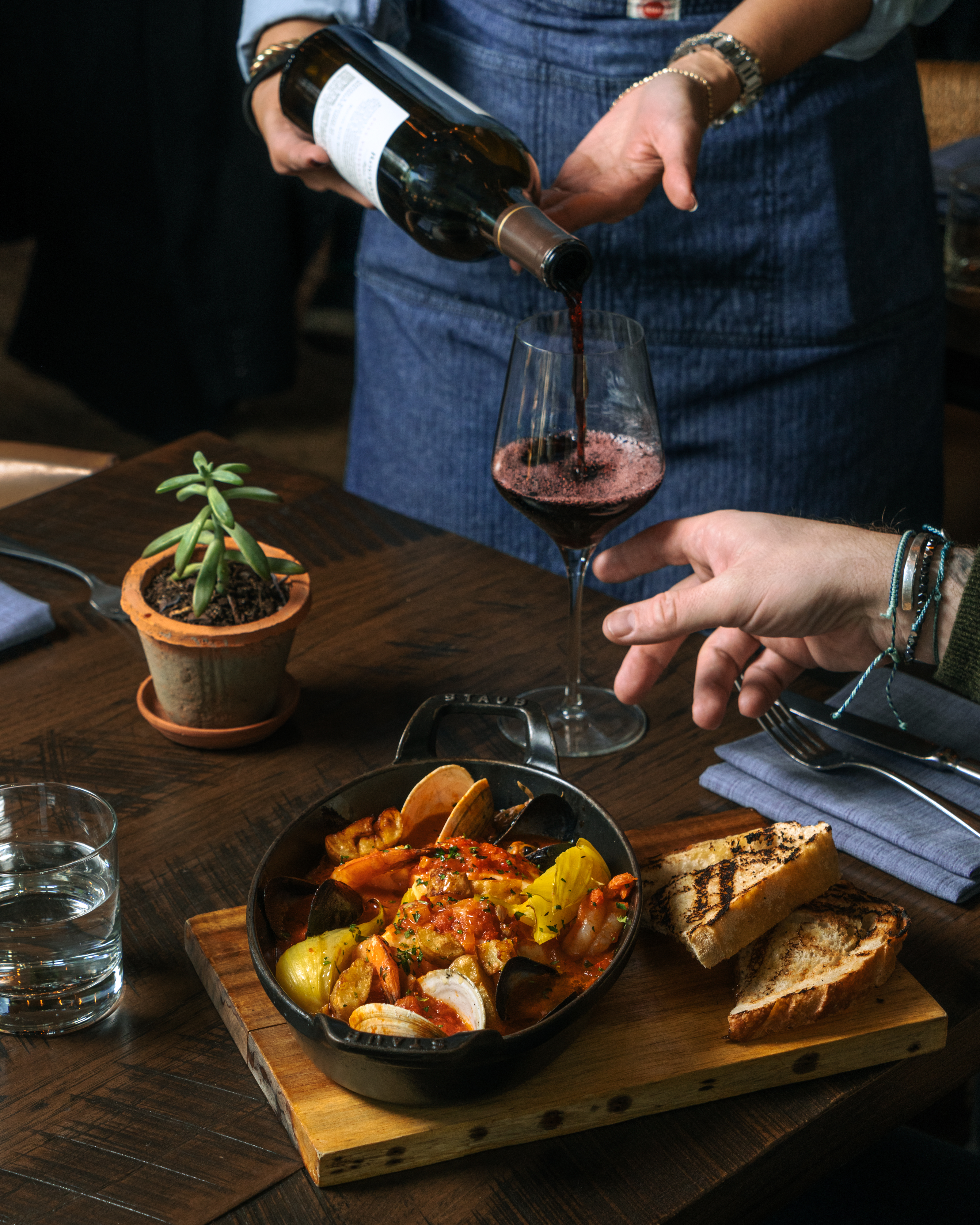 People being served wine during dinner