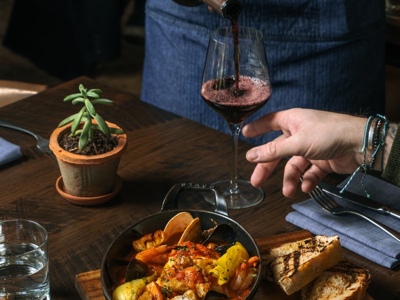 People being served wine during dinner