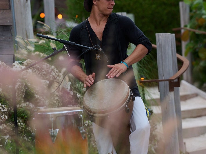 Person playing a drum at 1 Beach Club