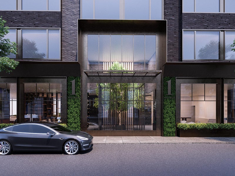 Black Tesla parked in front of a mock 1 Hotels building