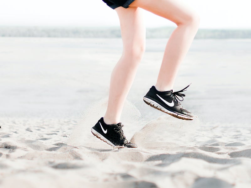 Legs running on the beach