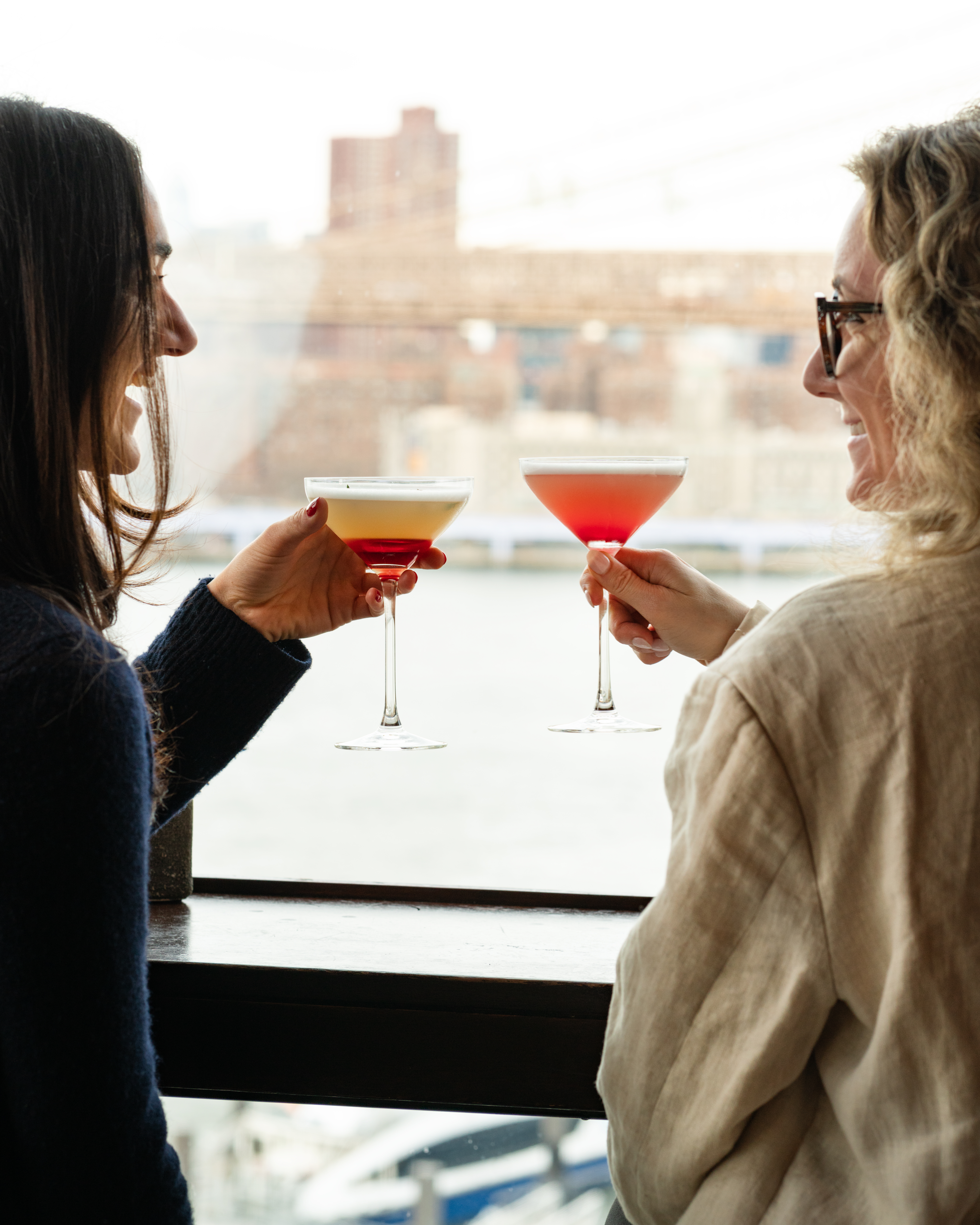 two women admiring the view with a cocktail