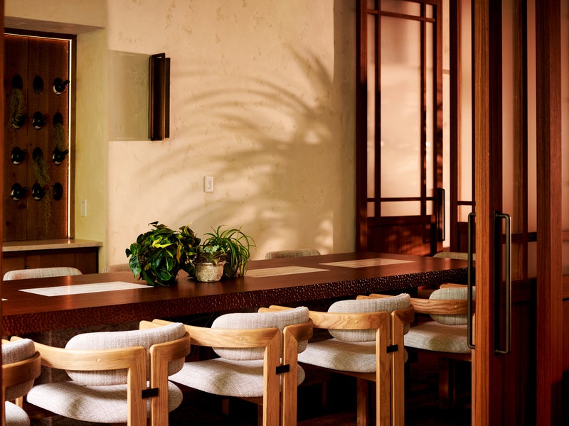 long stone table with wooden chairs