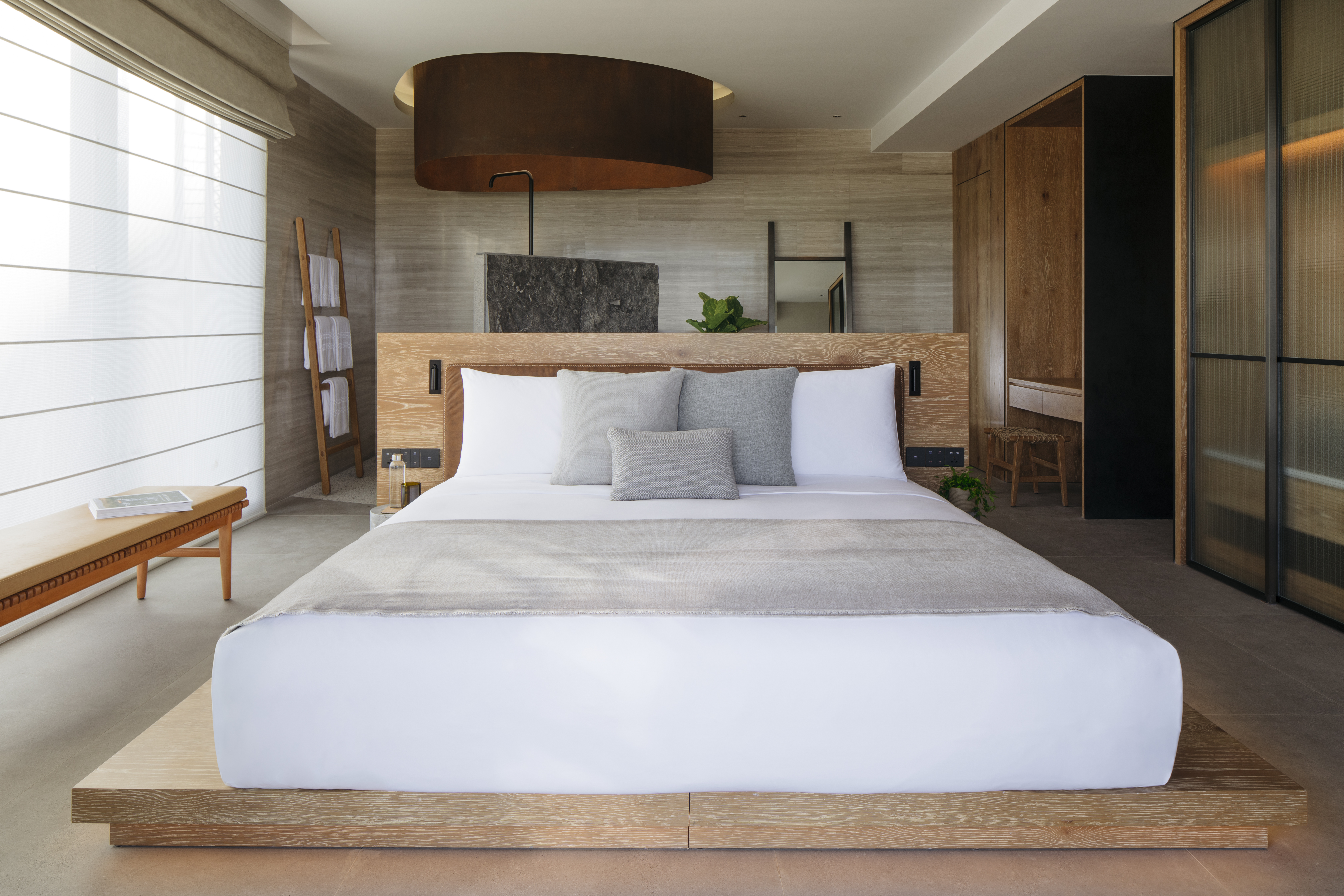 Made bed on a raised wooden frame