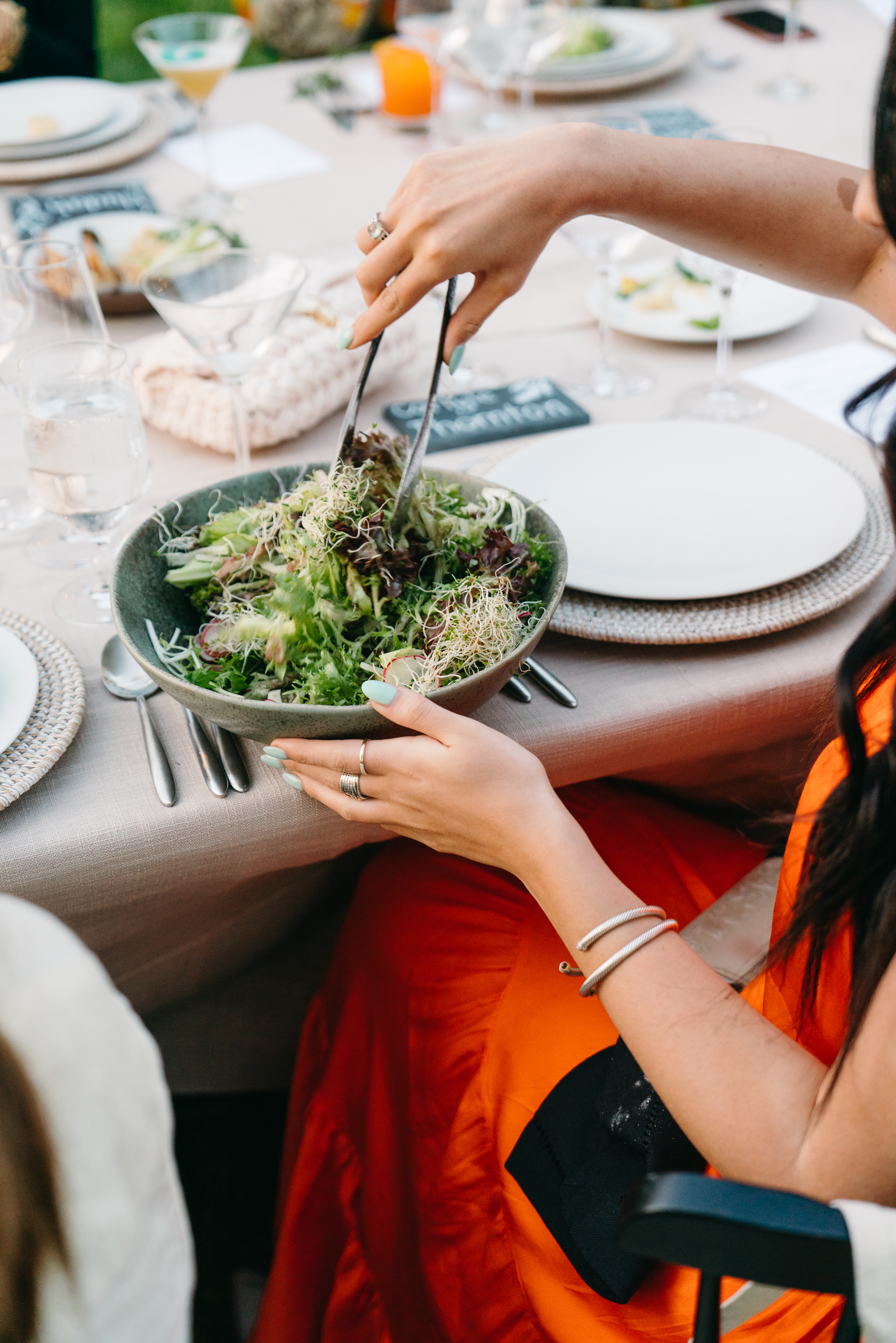 a person serving salad