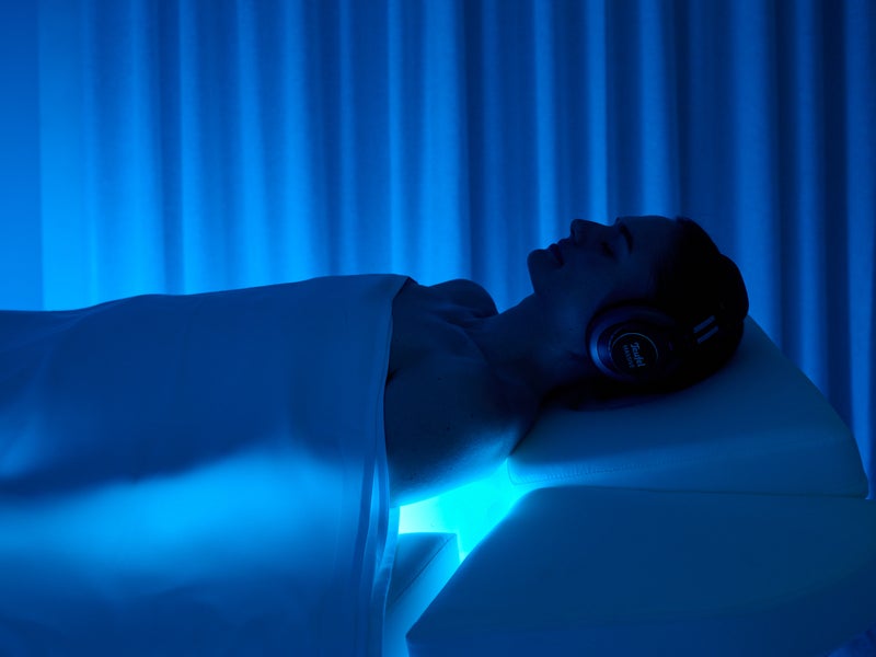 A person on spa bed with blue lighting in Melbourne Bamford Spa