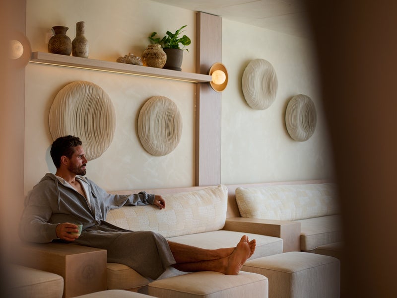 A man sitting on a couch at Bamford Spa