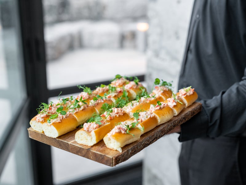 Caterer holding a tray of food 