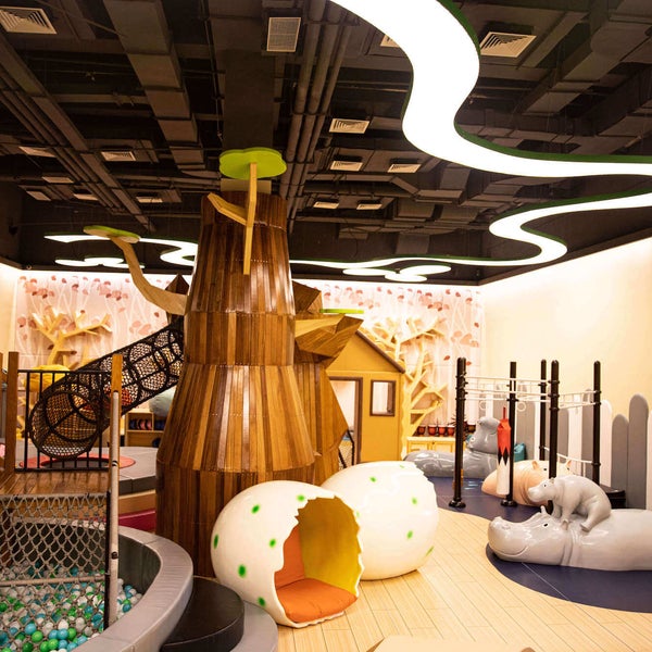 The children's play room inspired by nature, complete with ball pit, slide, and hanging rings