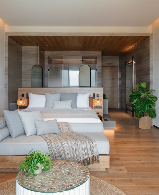 A couch and a bed in the Ocean Pool View room at 1 Hotel Haitang Bay