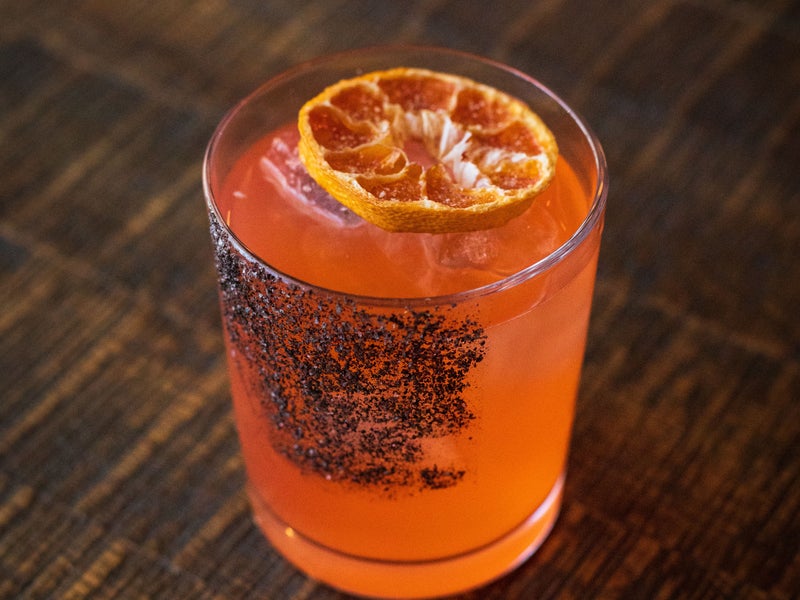 Orange cocktail with salt rim on the side of the glass