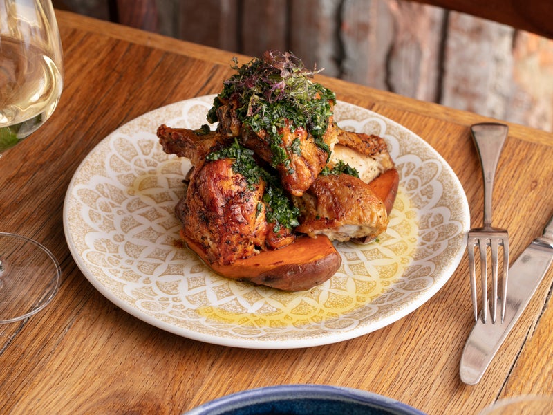 A plate with chicken and a side salad