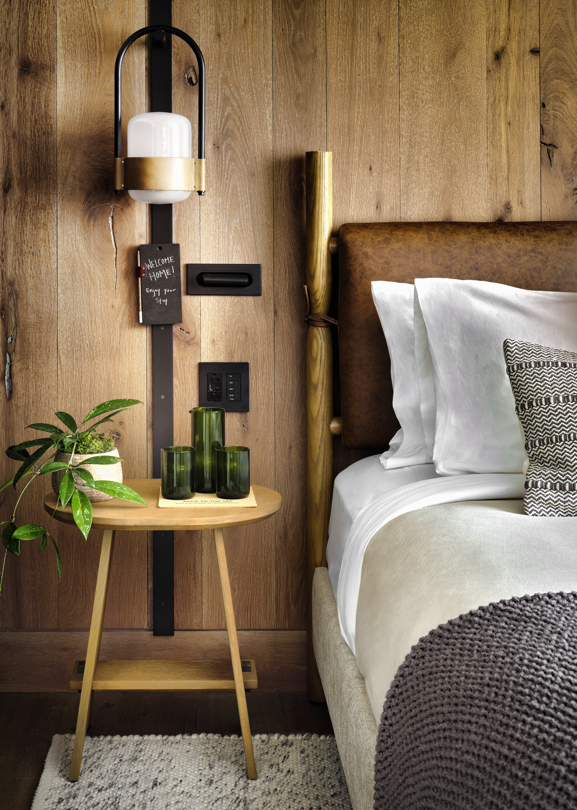 Side table with a "Welcome Home! Enjoy your stay" note