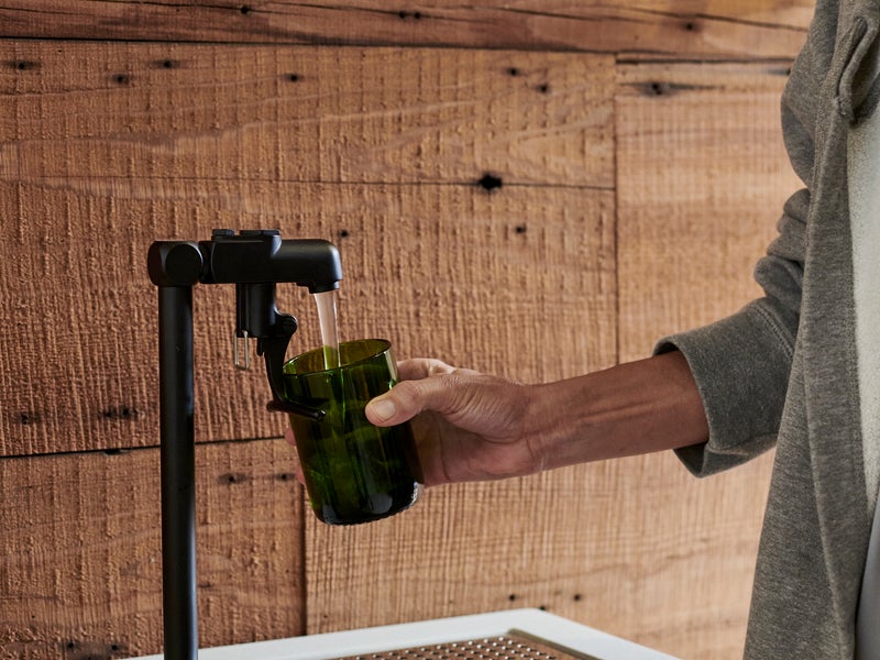Person dispensing water from a pump system