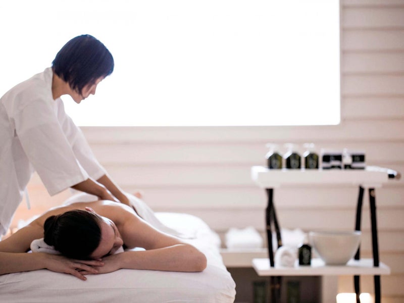 A person receiving treatment on a massage table