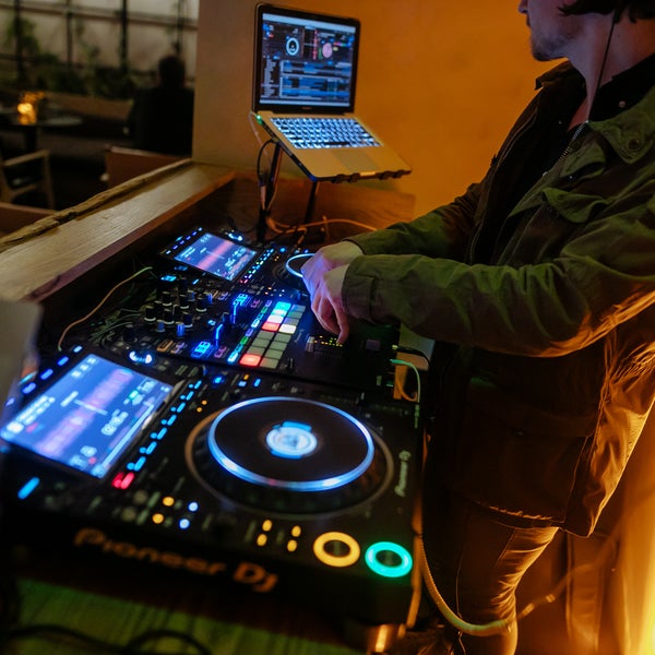 a person DJing, dj, sound board, event