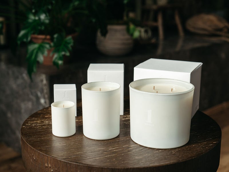 1 Hotels candles sitting on a table