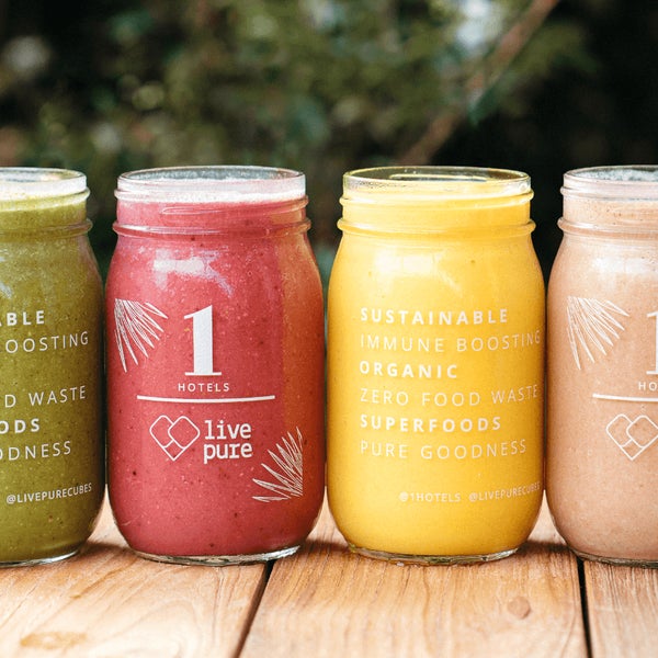 Four mason jars with smoothies lined up