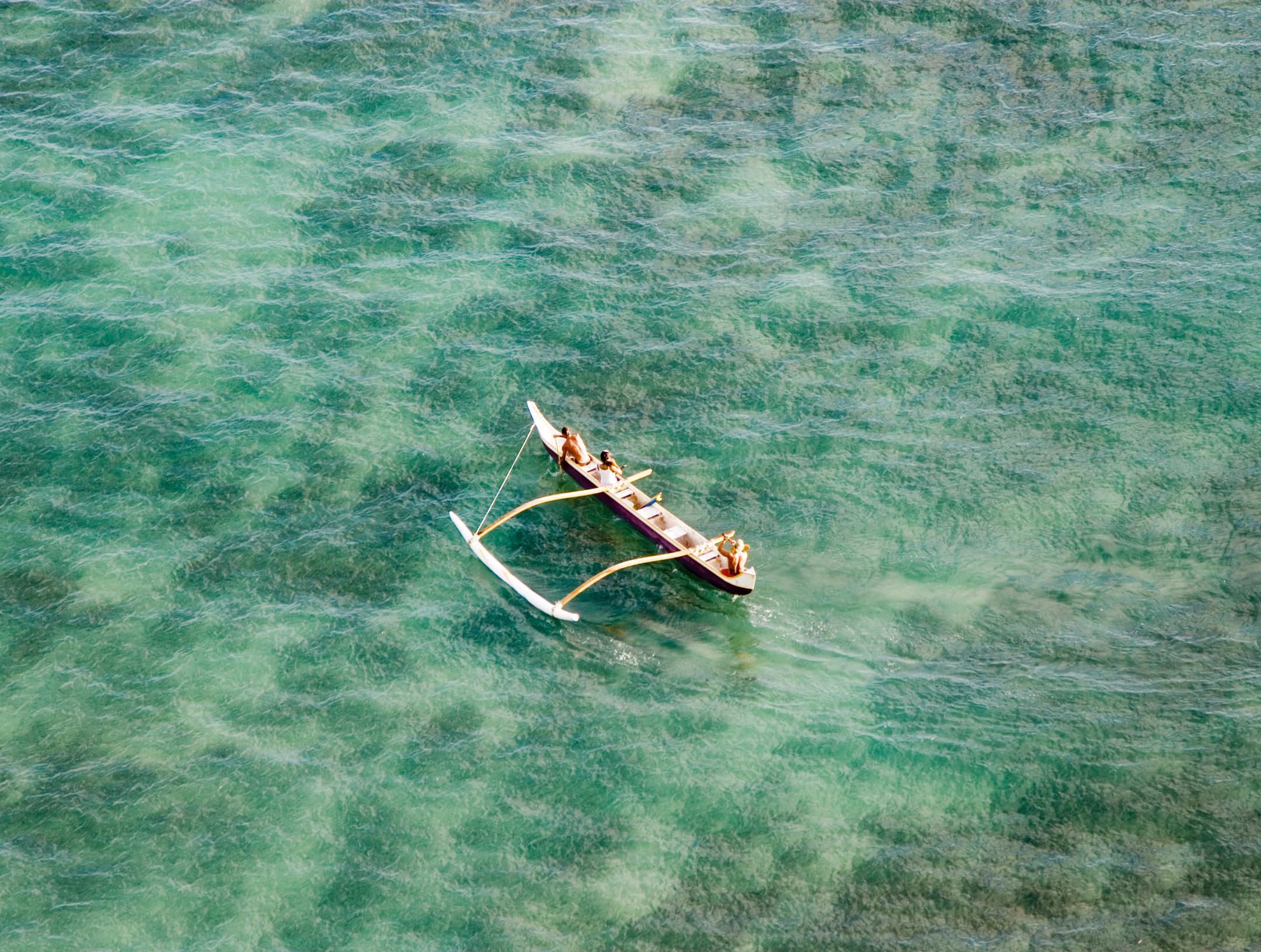 People on an outrigger on the water