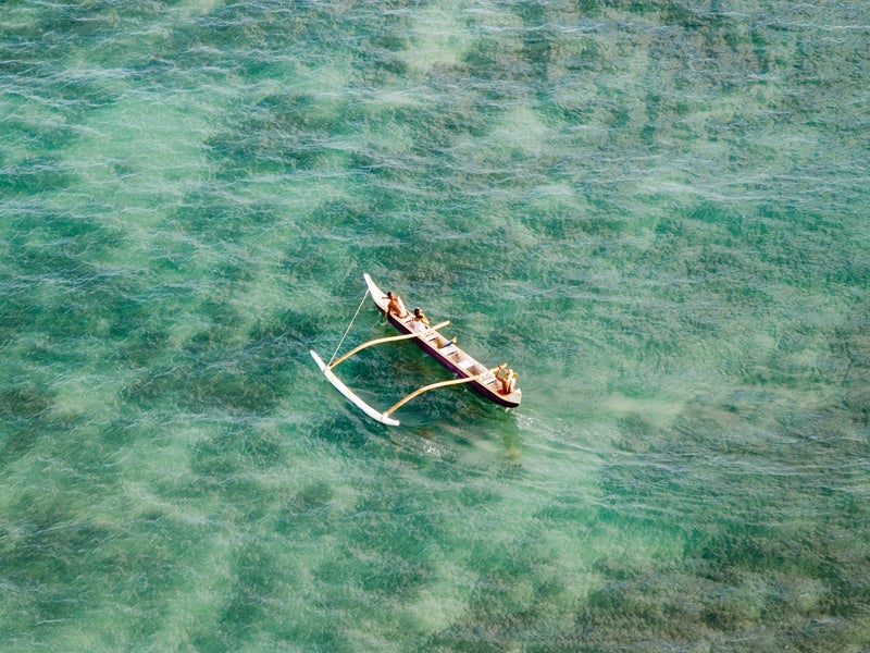 People on an outrigger on the water