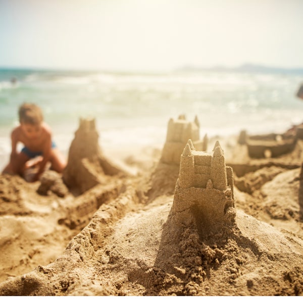 Children building a sandcastle on the beach