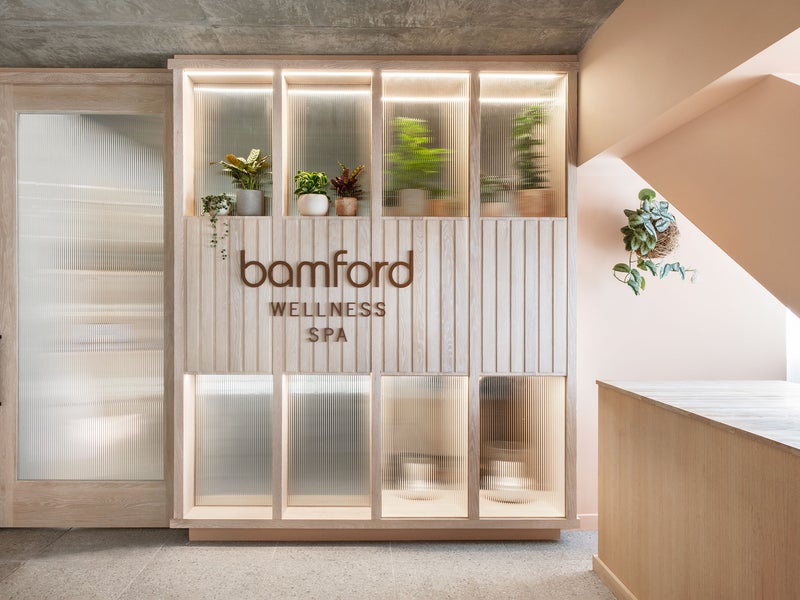 Bamford Wellness Spa sign with potted plants on top