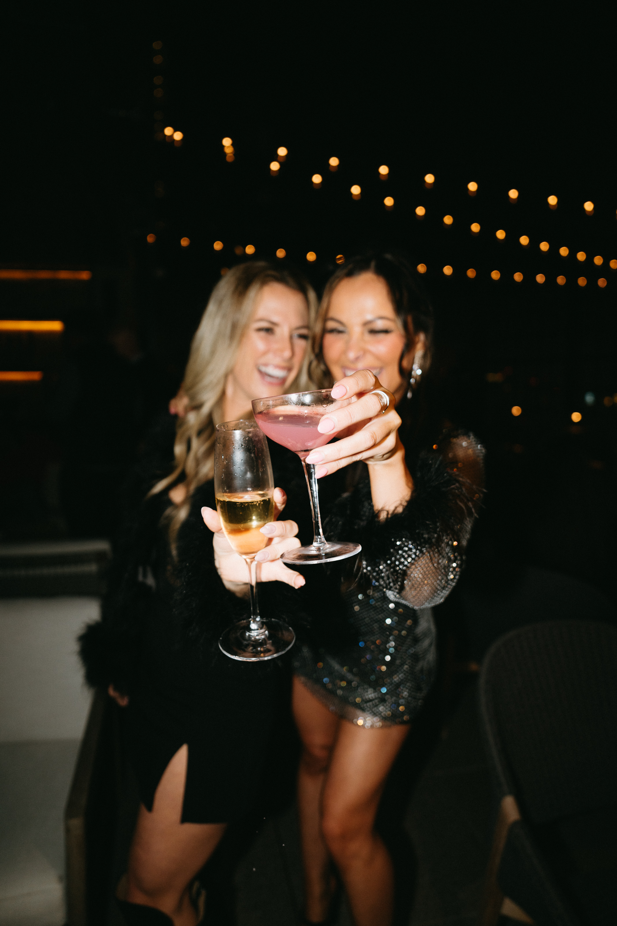 two girls with cocktails