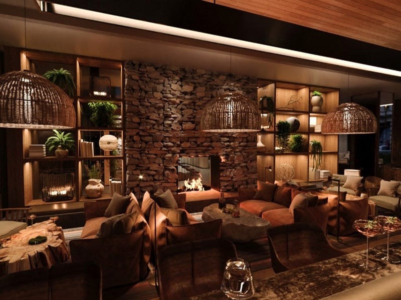 A bar with comfortable seating and a fireplace