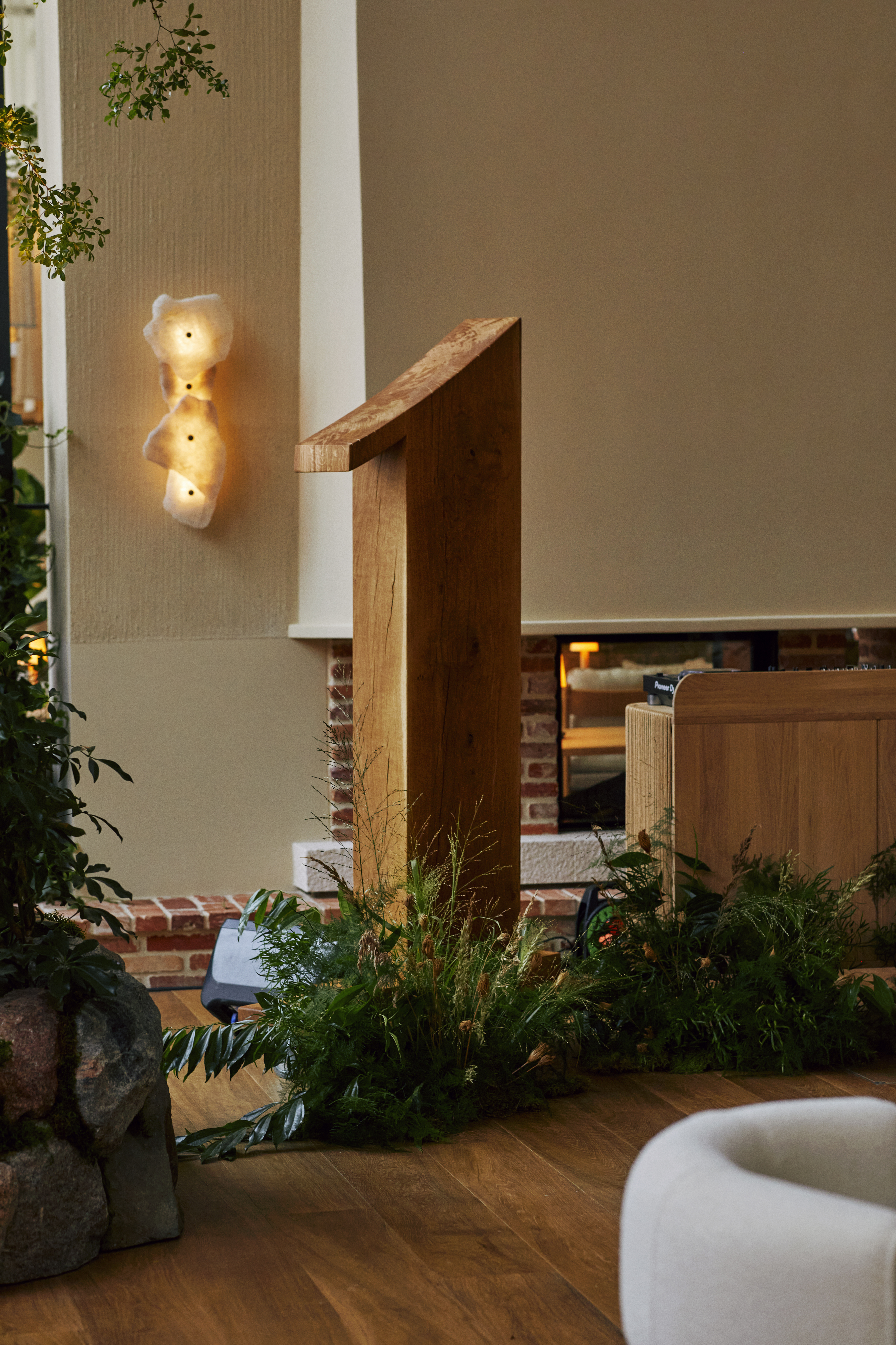 A wooden "1" sign with greenery decorated around it