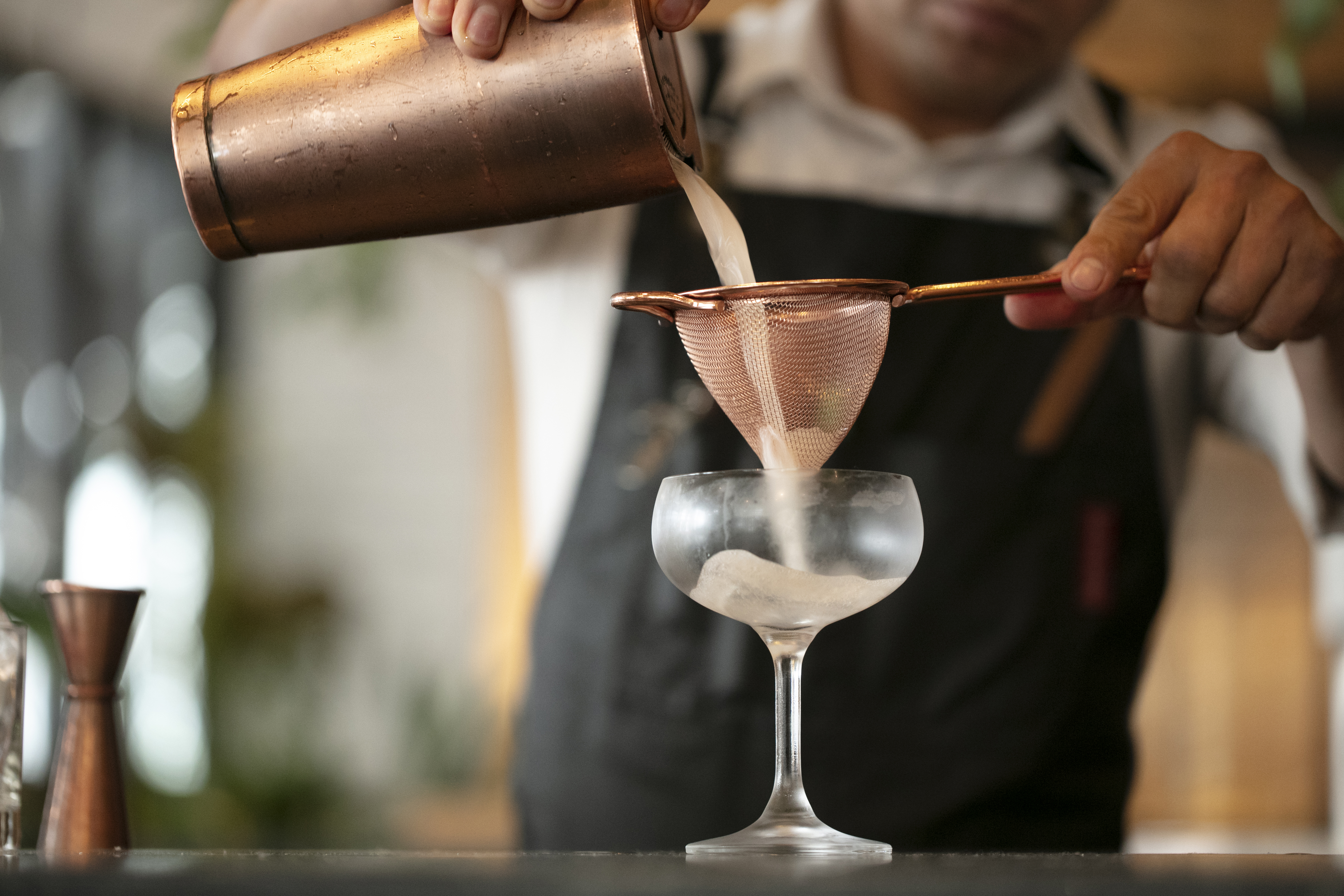 pouring and straining cocktail