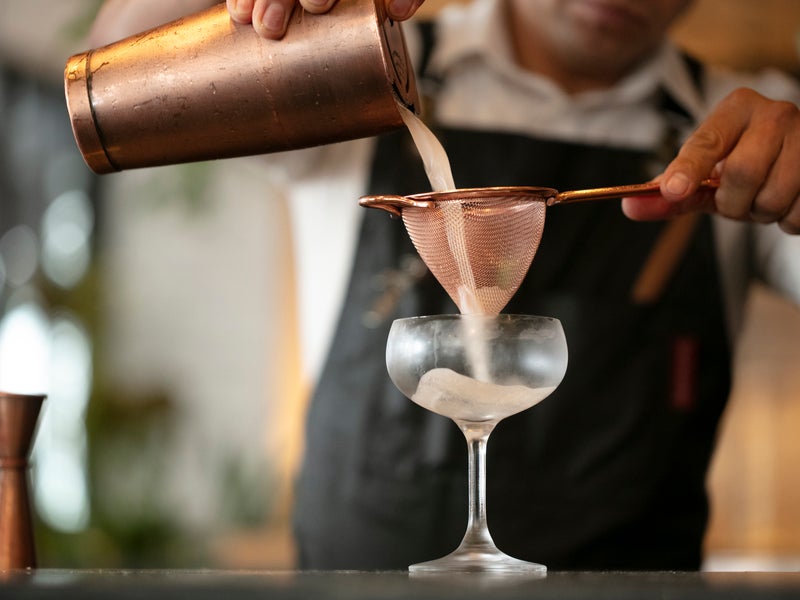 pouring and straining cocktail
