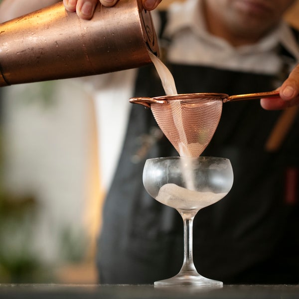 pouring and straining cocktail