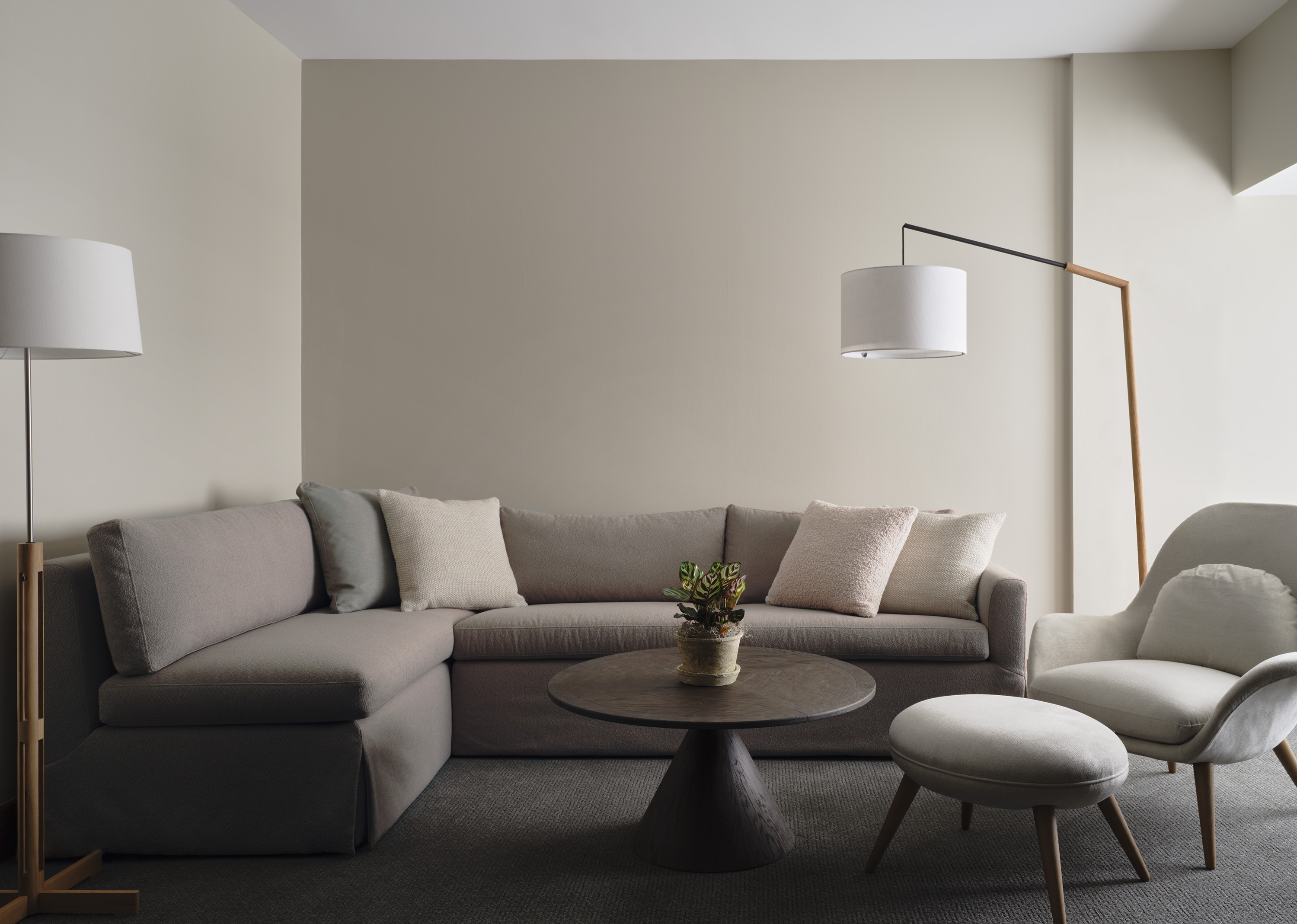 Dark themed living room area with sectional couch