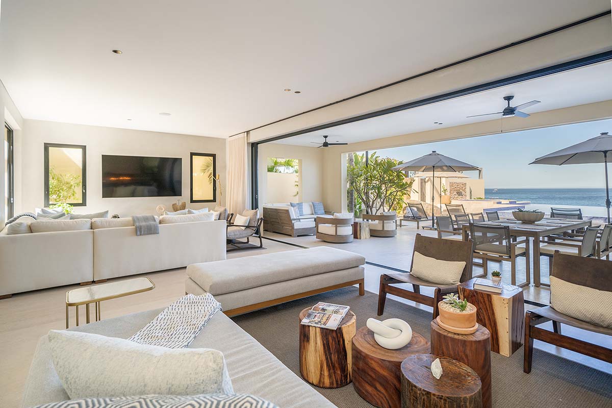 A large living room with a sectional couch and benches