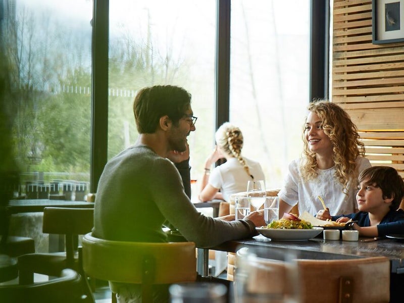 Family sitting at a table eating breakfast