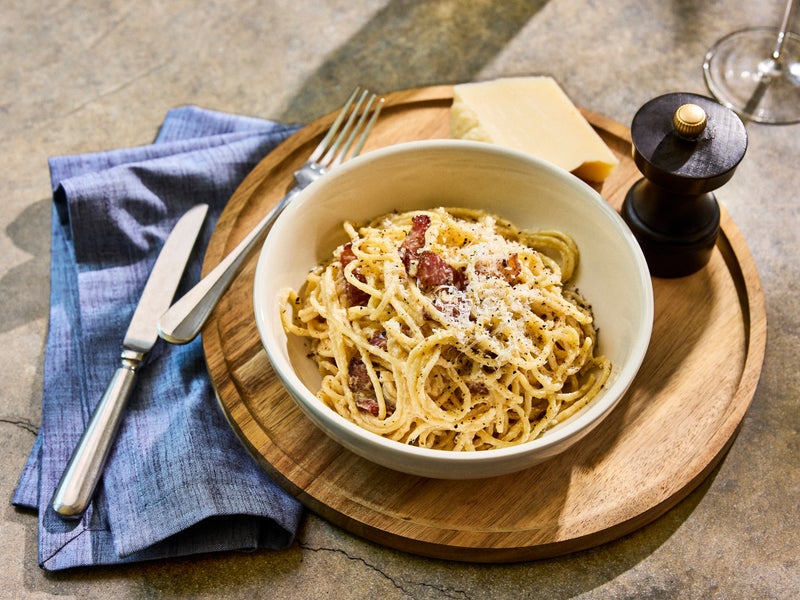 plate of pasta with a glass of white wine