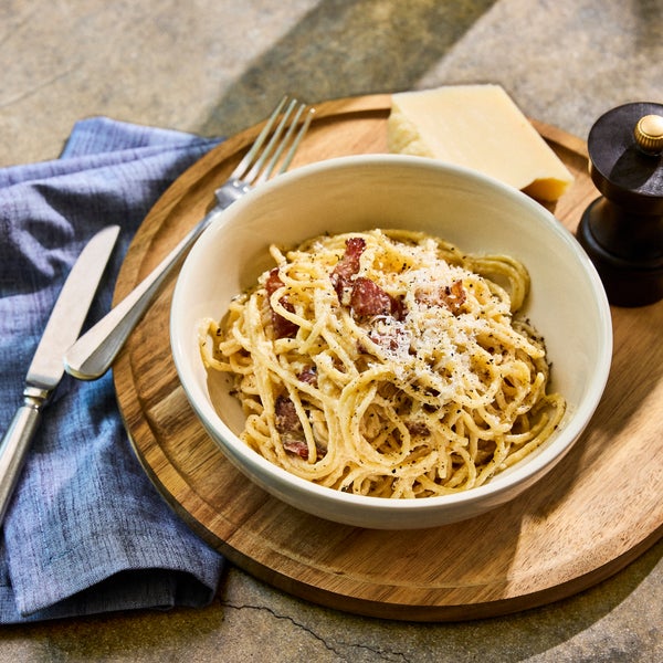 plate of pasta with a glass of white wine