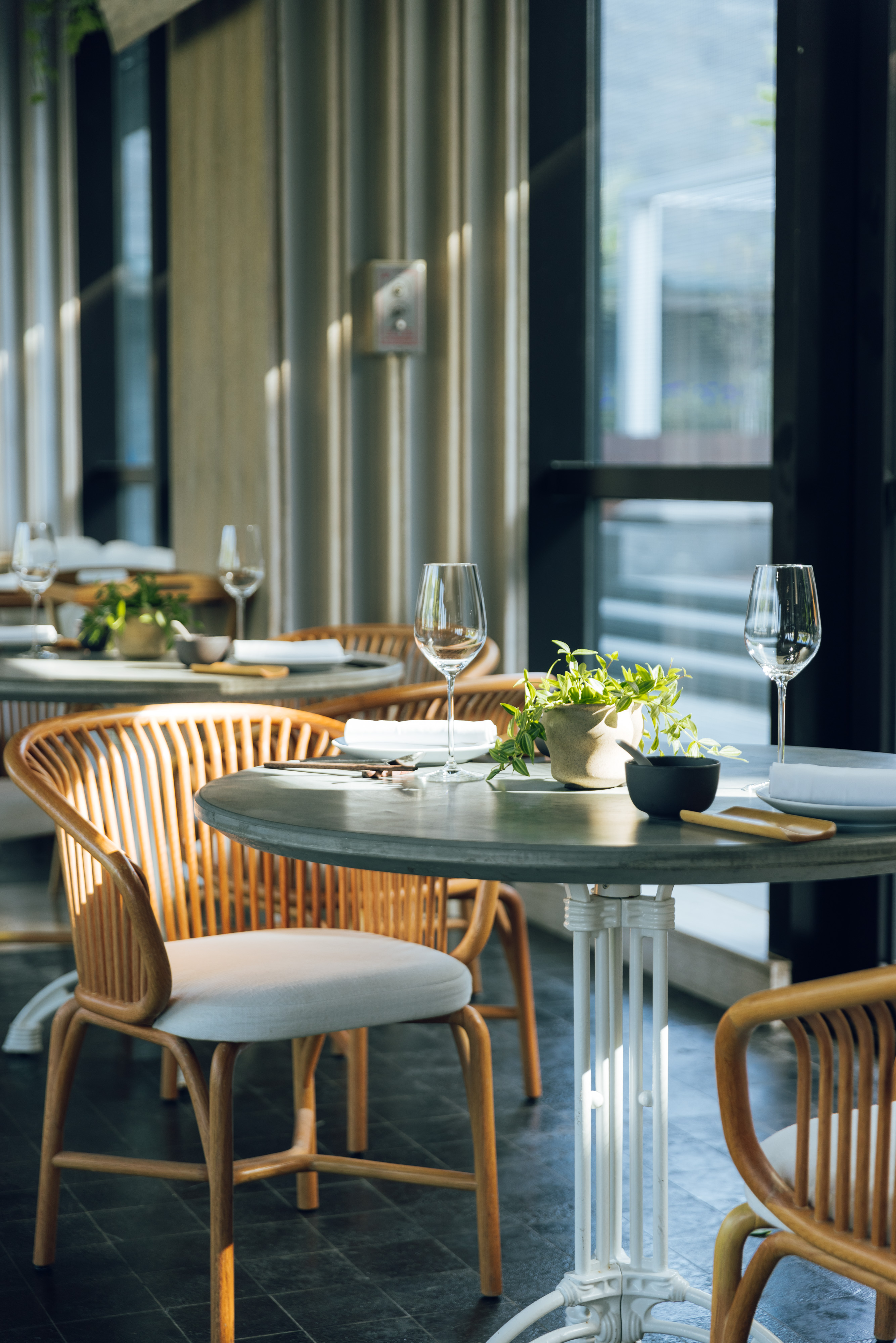 Green House tables in front of a window