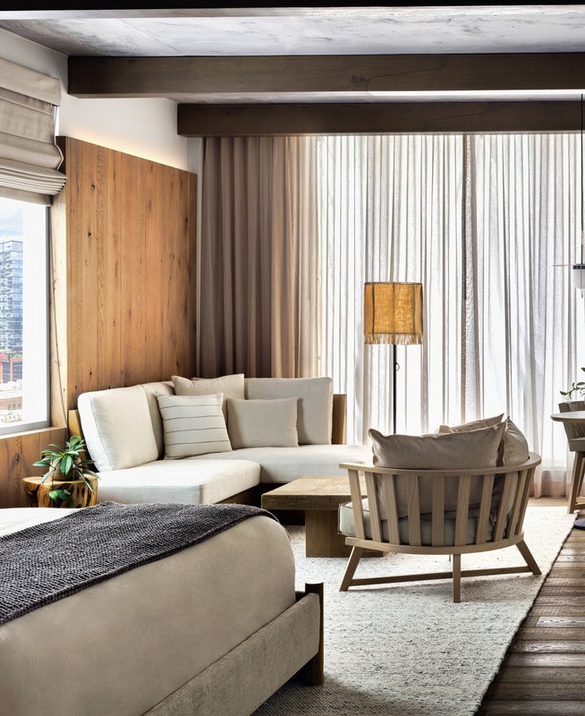 A well lit bedroom with a king size bed and sitting area