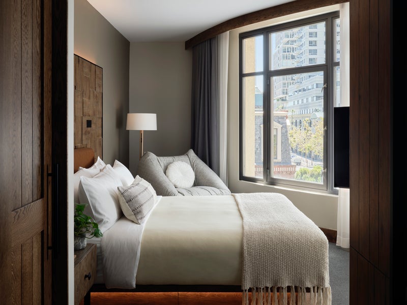 Looking into a Studio suite room with king bed overlooking views of the city