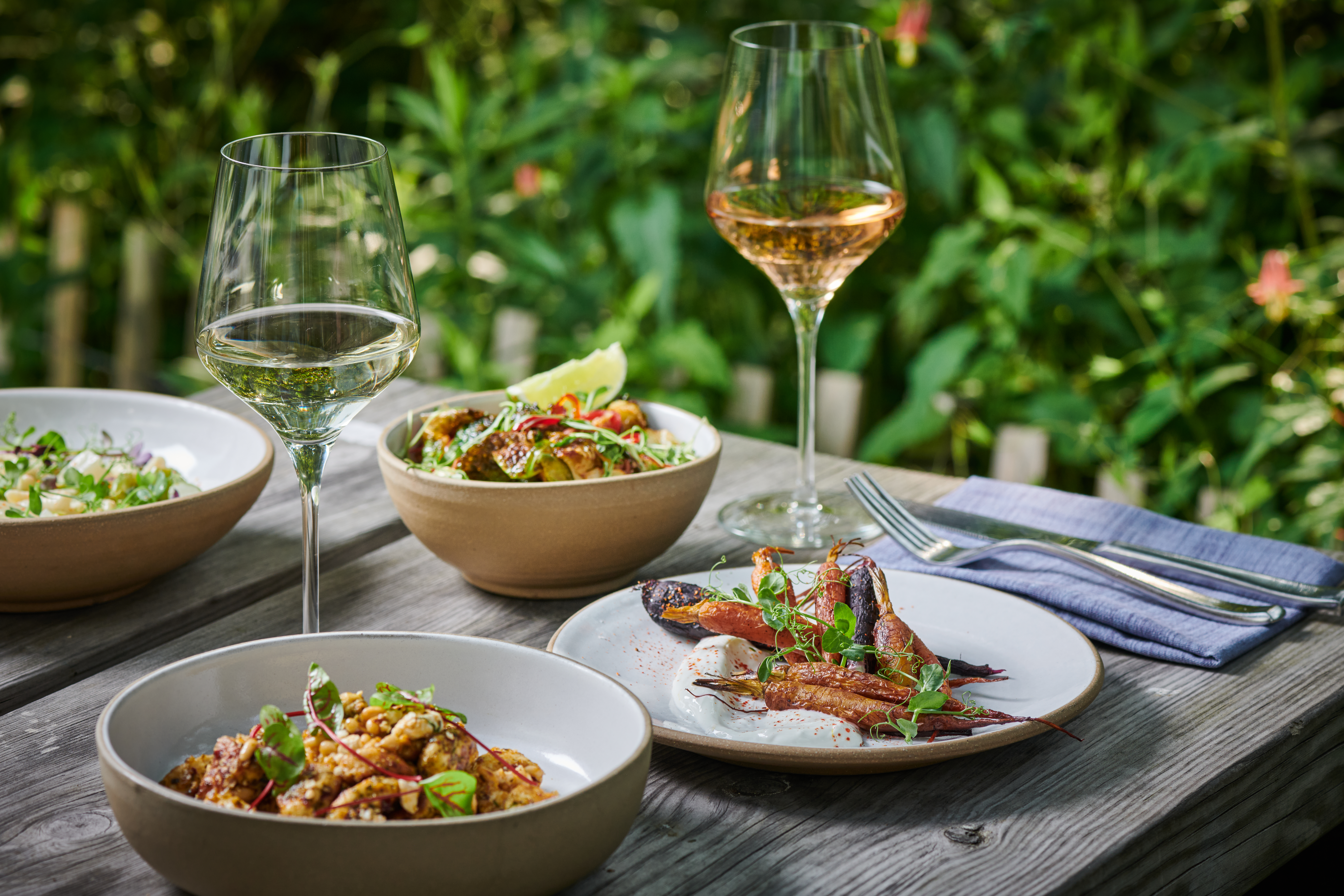 Table set with cutlery, drinks and food