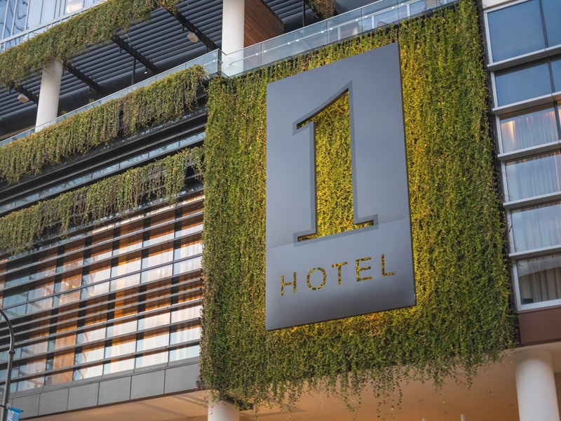 1 Hotels logo with moss hanging from the wall