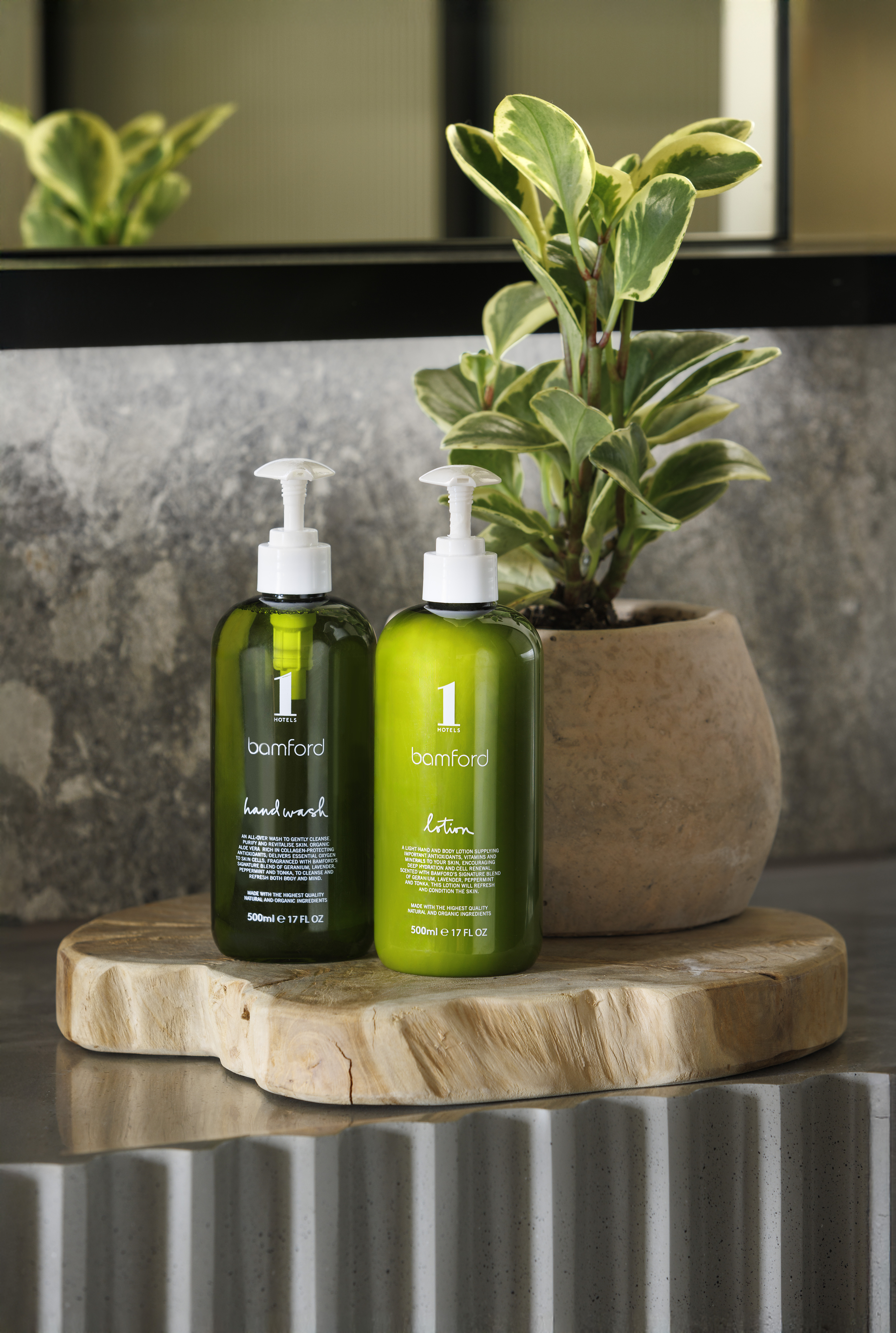 green bottles of lotion next to a plant