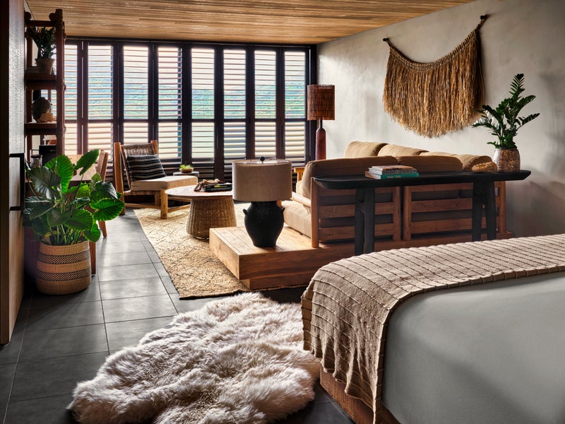 Bedroom with king size bed overlooks a spacious living area 