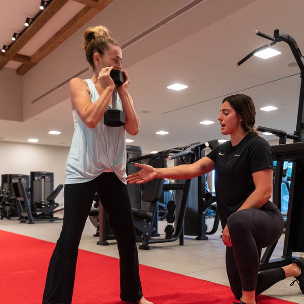 A woman exercising with her personal trainer