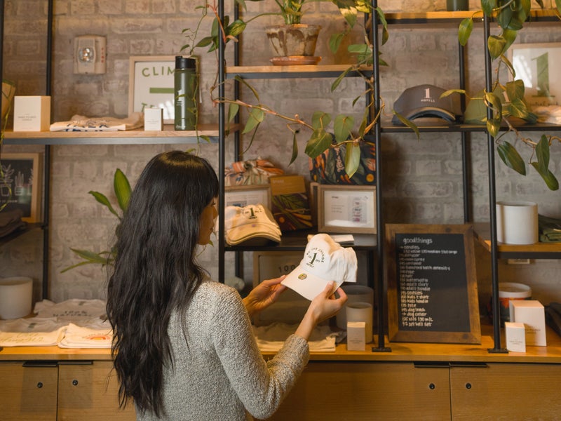 A woman looking at an item from a shelf