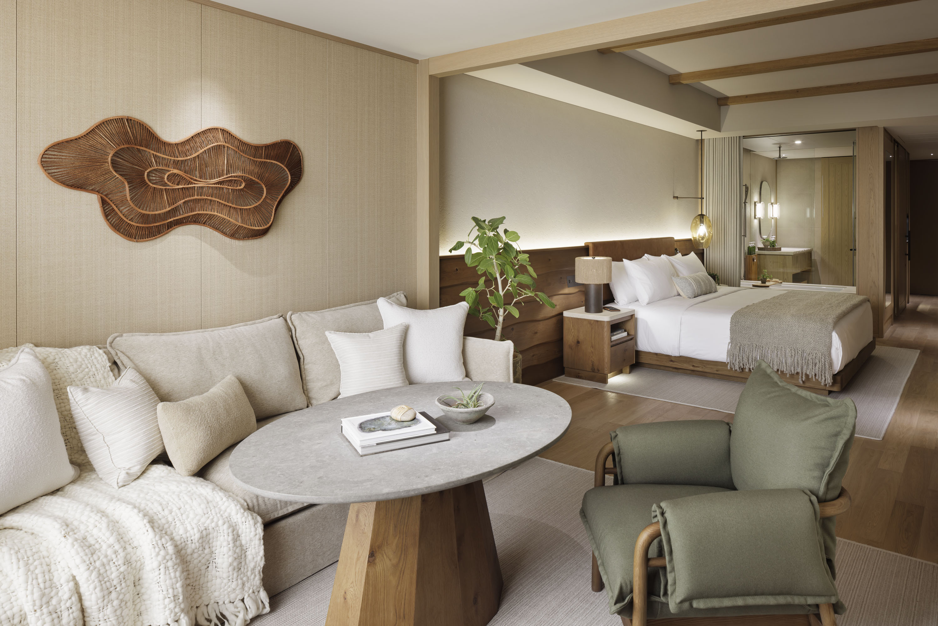 Warm-toned large room with bed, couch, and bathroom