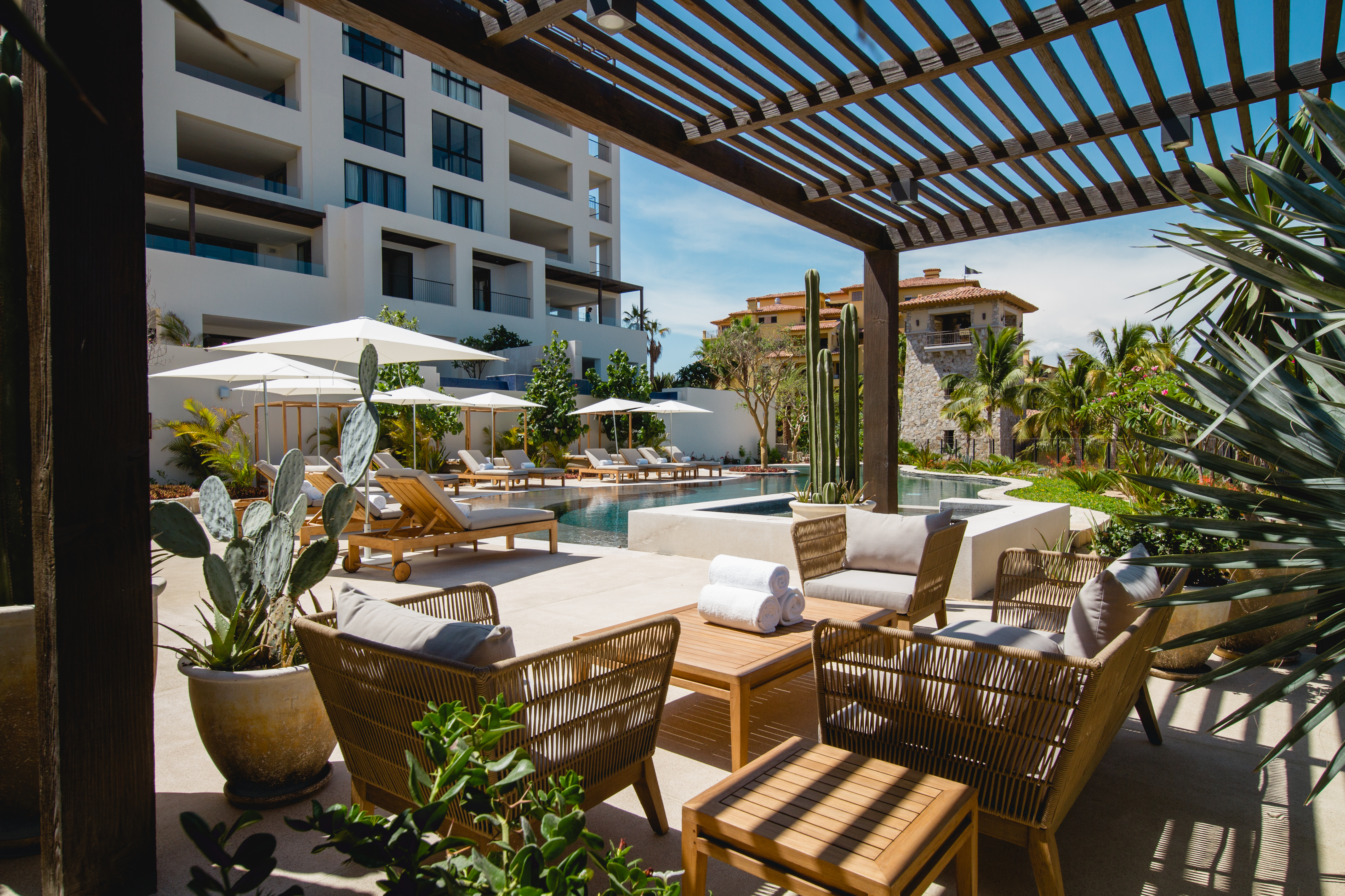 Covered seating area outside next to a pool